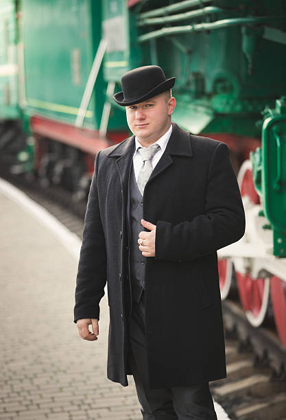 istock handsome man in suit and bowler hat waiting for train 522314082