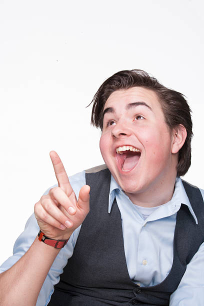 Caucasian young man pointing upward