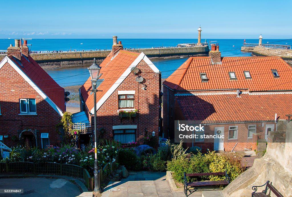 Scenic view of Whitby city in autumn sunny day Scenic view of Whitby city in autumn sunny day.Whitby's attraction as a tourist destination is enhanced by its association with the world famous horror novel Dracula, written by Bram Stoker Abbey - Monastery Stock Photo