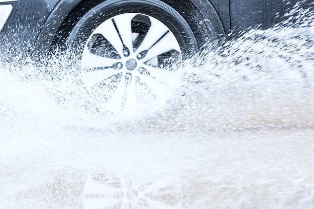 istock car rain puddle splashing water 522314884