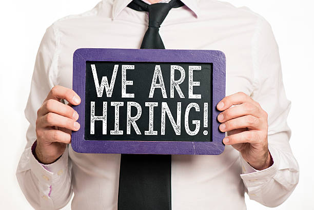 istock We're hiring handwritten on a blackboard which holding man 522315585