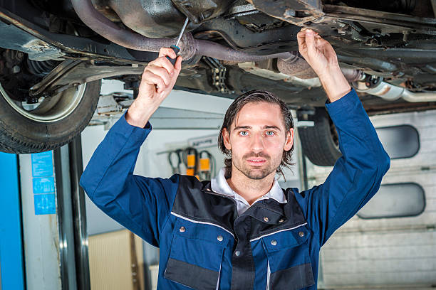istock Mechanic checking the condition of a lifted car 522315962