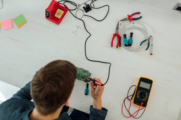 istock Man Soldering a circuit board in his tech office. 522316100