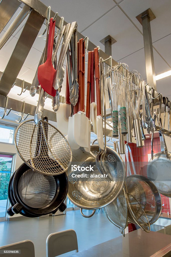 Cooking Utensils on Rack Pot rack for a commercial kitchen.Pot rack for a commercial kitchen.Pot rack with utensils for a commercial kitchen. Aluminum Stock Photo