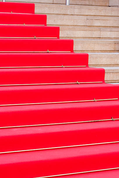 istock Red carpet on stairway, copy space 522317397