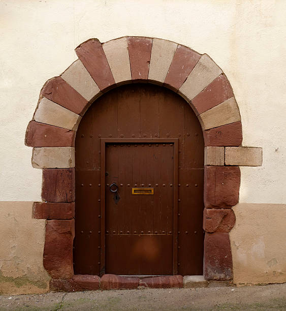 Old wooden door in a stone facade stock photo