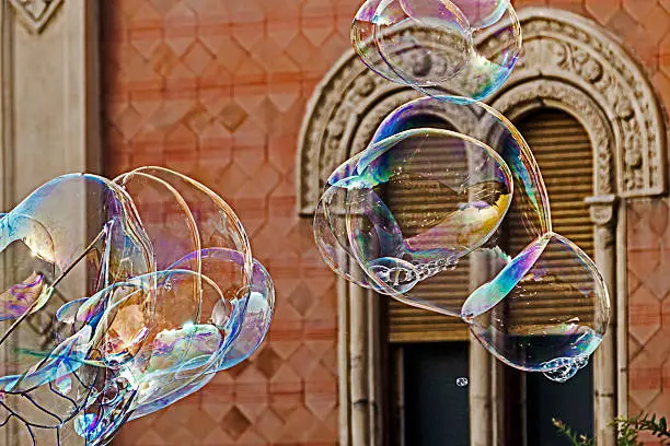 Giant soap bubbles on a background of historic building.