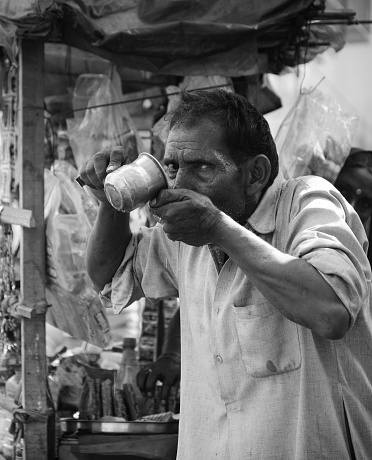 faridabad,India-October 15, 2013: a men drinking water while staring me, sector-14.faridabad