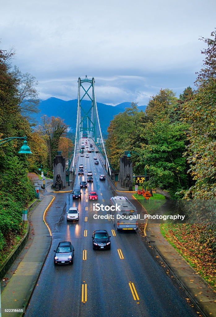 South End of Lions Gate Bridge on Rainy Day Vertical image looking north at the Lions Gate Bridge in Vancouver.  Image taken from Stanley Park Drive overpass.  Image taken on heavily overcast and rainy day in early autumn. Vancouver - Canada Stock Photo