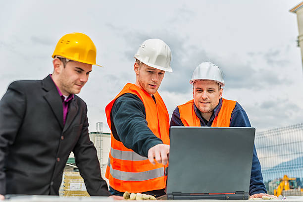 Architect and construction team Three caucasian engineers discussing the plans in a laptop. geologist stock pictures, royalty-free photos & images
