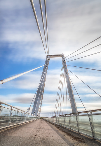 Cable Bridge in Umea, Sweden with a partly cloudy sky.