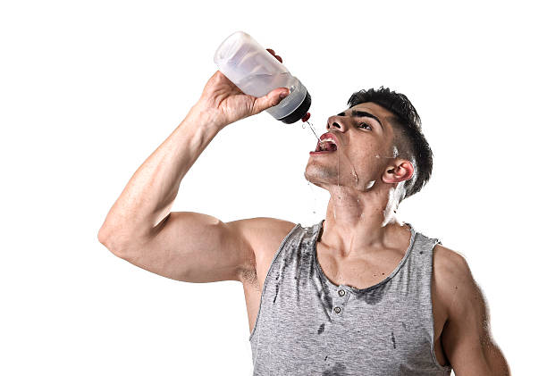 istock sport man drinking water holding bottle pouring on sweaty face 522321962