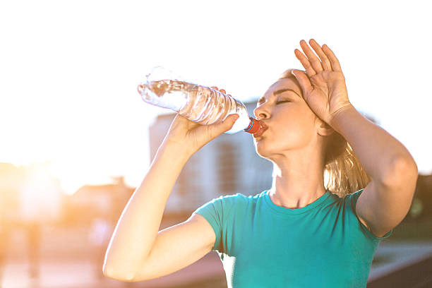 istock Woman athlete drinking water from a bottle 522322478