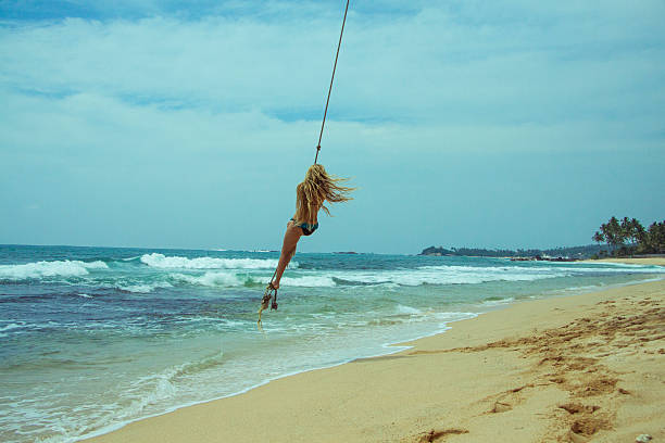 istock Woman  swinging at beach 522323824