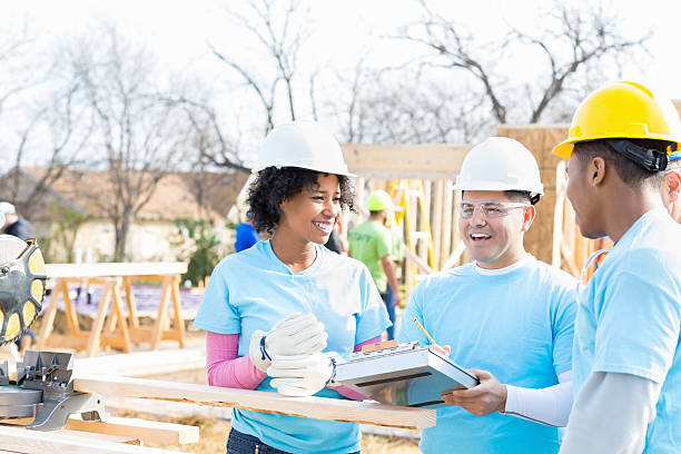 istock Diverse volunteers discuss charity construction project 522325210