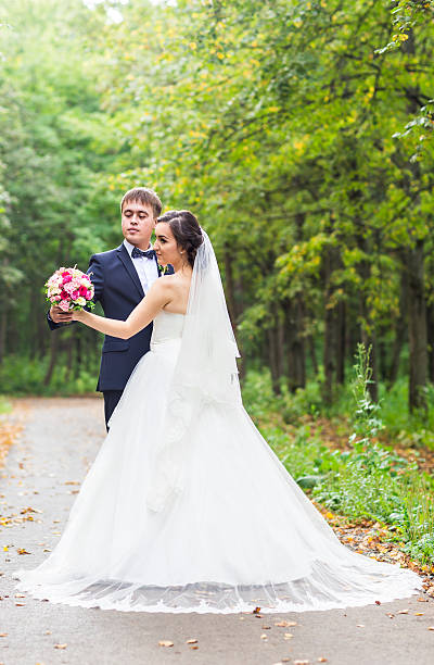 istock Bride and groom at wedding Day walking Outdoors. Happy Newlyweds 522326604