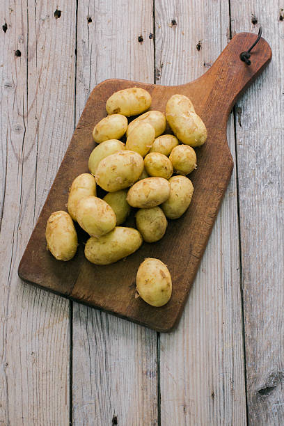 istock Fresh organic potatoes on a wooden table 522328376