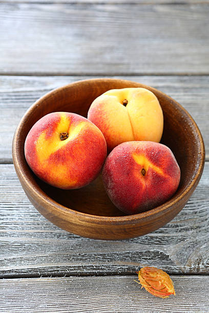 istock fragrant and fresh peaches in wooden bowl 522328957