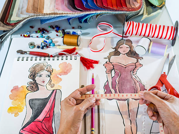 istock Fashion designer working with material and hand-drawn illustration 522329273