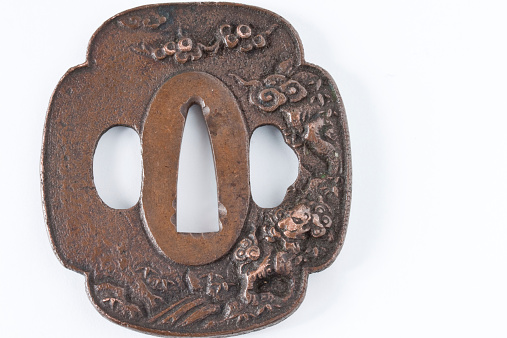This is the hand guard (Tsuba) of the Japanese sword.