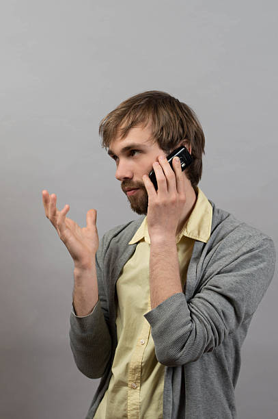 istock Man talking on the phone. On a gray background. 522329648