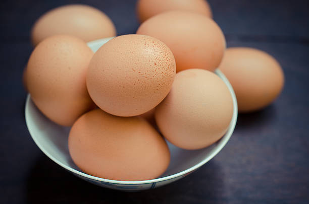 istock Eggs in bowl on wooden table background 522330101