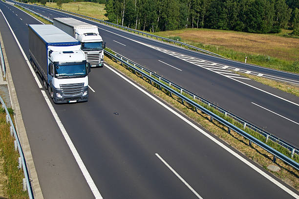 istock Two overtaking the white trucks on highway in the landscape. 522330252