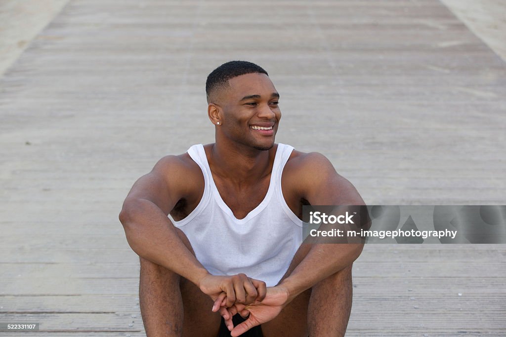 Cool guy smiling and sitting outdoors Portrait of a cool guy smiling and sitting outdoors 20-24 Years Stock Photo