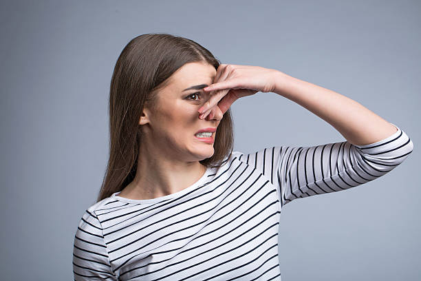 istock Pleasant girl closing her nose 522331394