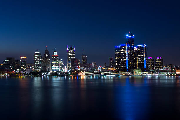 Detroit Skyline The Detroit Skyline at twilight from Windsor, Ontario, Canada. woodward stock pictures, royalty-free photos & images