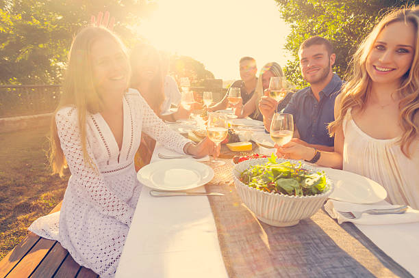 istock Group of young people eating outdoors. 522331632