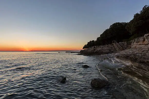 Sunset rocky beach in Istra, Croatia. Solaris summer resort, Adriatic Sea, Lanterna peninsula.