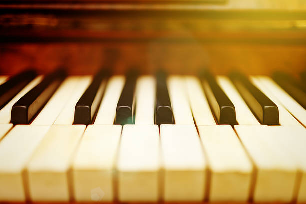 istock Antique piano keyboard in soft golden light 522331710