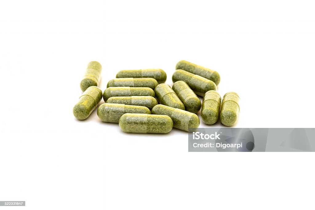 Green chlorophyll capsules Green chlorophyll capsules on white background Acid Stock Photo