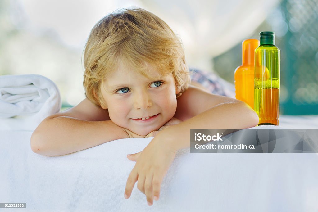 Little kid boy relaxing in spa with enjoying massage Little kid boy relaxing in spa and enjoying massage. Affectionate Stock Photo