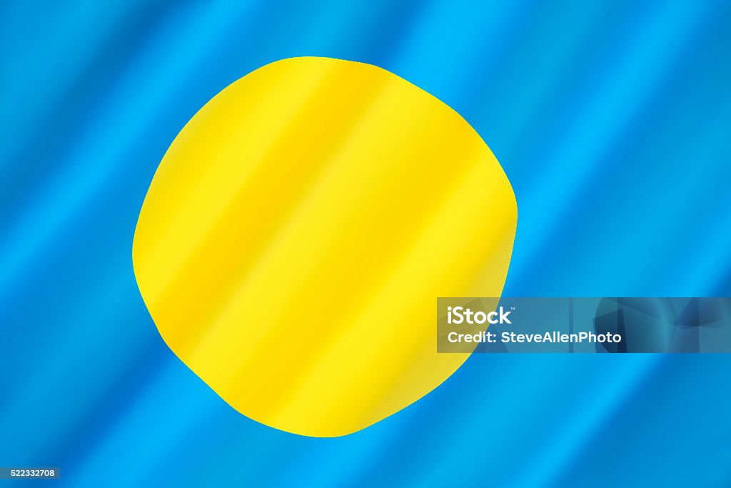 Flag of Palau Flag of Palau - adopted on 1st  January 1981, when the island group separated from the United Nations Trust Territory. The yellow disc represents the moon and is off-centre on a blue background that represents the ocean. Colors Stock Photo