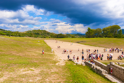 Olympia, Greece - September 7, 2014: Tourists entering ancient Olympic Stadium in Olympia, Greece.