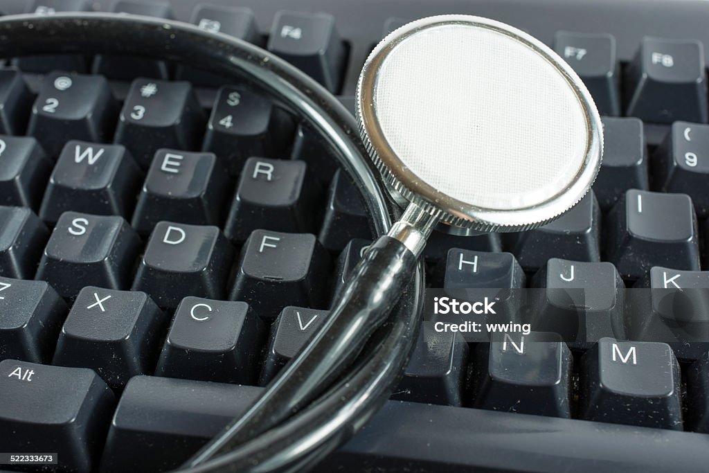 Stethoscope on Black Computer Keyboard A stethoscope on a black Close-up Stock Photo