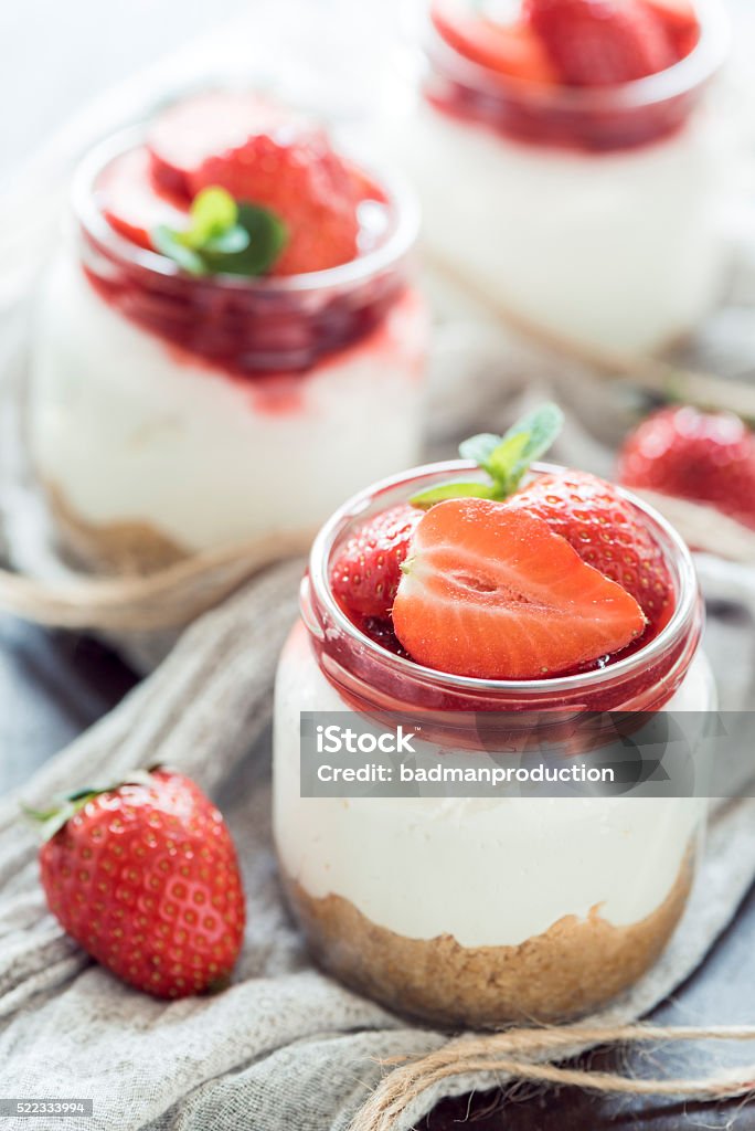 Strawberries cheesecake in jar Fresh strawberries in homemade cheesecake,selective focus Cheesecake Stock Photo