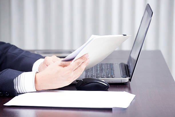 istock hand of businessman holding a document 522334569
