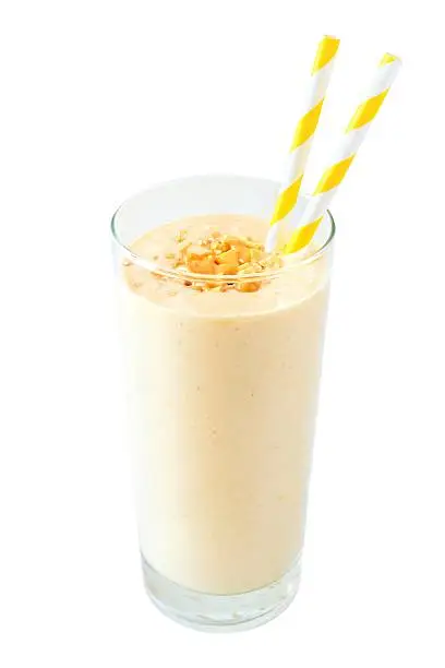 Peanut butter banana oat breakfast smoothie with paper straws isolated on a white background