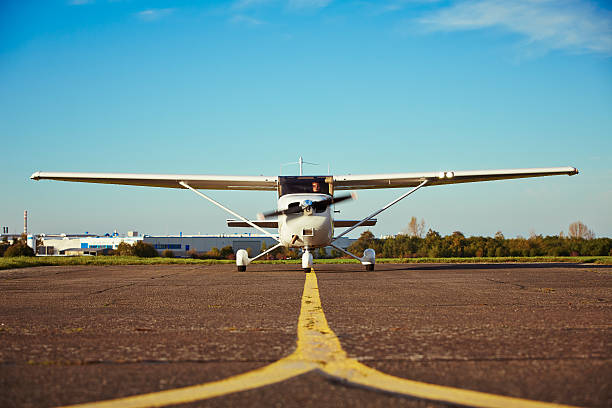 Private airplane Young pilot is preparing for take off with private plane. airfield stock pictures, royalty-free photos & images