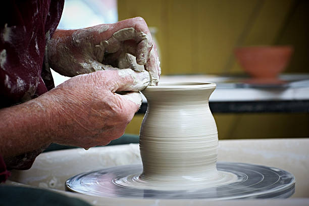 istock Potter moulding clay on a pottery wheel 522336803