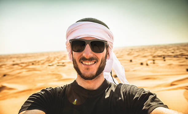 istock tourist man doing a selfie on the desert 522344167