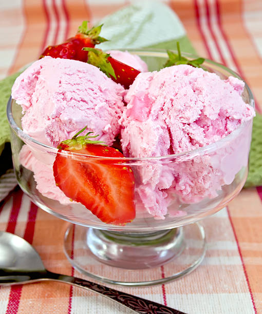istock Ice cream strawberry in glass goblet on tablecloth 522345645