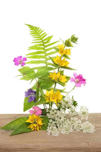 Arrangement of wild flowers on a weathered wooden board