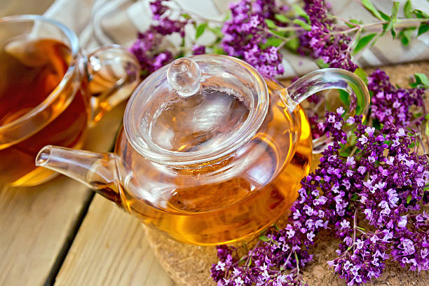 istock Tea of oregano in glass teapot on board 522355281