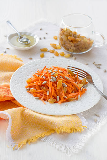 Carrot salad with raisins, sunflower seeds and honey
