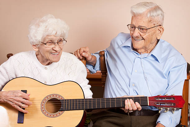 istock Senior Couple Singing and Playing Guitar 522359321