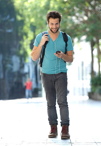 istock Young man traveling with bag and mobile phone 522360851